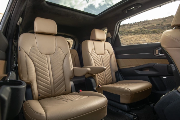 2024 Kia Sorento interior, three-quarter front view of the second row captain chair seats in brown leather