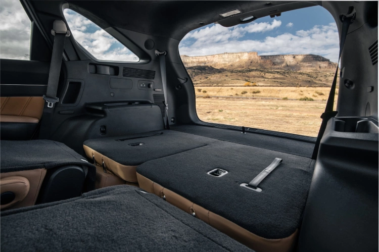 2024 Kia Sorento interior view of the cargo space with the second and third row seats folded down and the trunk open revealing an open desert
