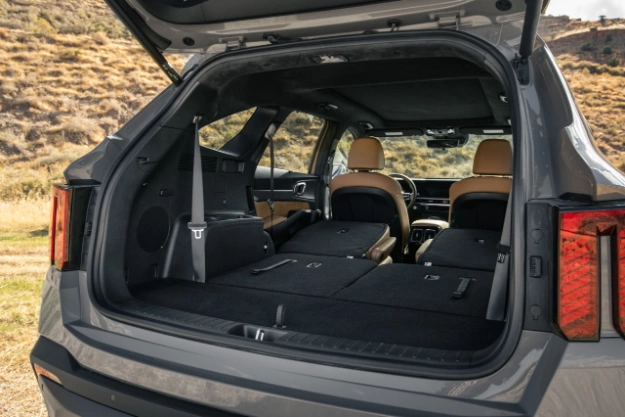 2024 Kia Sorento back view with the trunk open, second and third row seats folded down to show a large cargo space