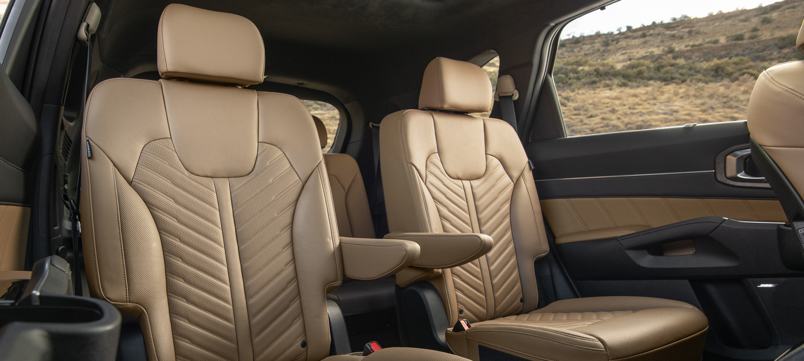 2024 Kia Sorento interior, three-quarter front view of the second row captain chair seats in brown leather