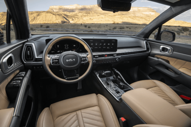 2025 Kia Sorento X-Pro SX Prestige AWD interior, full view of the driver cockpit, featuring a two-tone wheel and Dual Panoramic Display