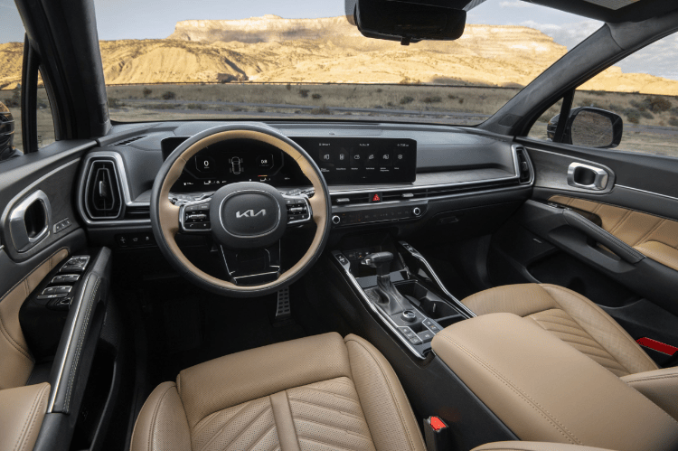 2025 Kia Sorento X-Pro SX Prestige AWD interior, full view of the driver cockpit, featuring a two-tone wheel and Dual Panoramic Display