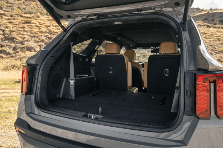 2025 Kia Sorento back view with the trunk open, second and third row seats folded down to show a large cargo space