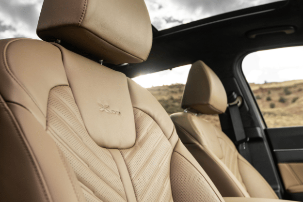 2025 Kia Sorento X-Pro SX Prestige AWD interior, three-quarter zoomed in view of the second row captain chairs, highlighting the light brown genuine leather seat trim