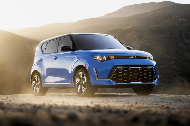 2024 Kia Soul In Surf Blue Parked On A Hill-Side Patch Off-Road Three-Quarter View