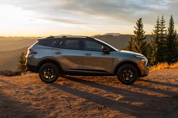 2023 Kia Sportage Parked On Top Of A Mountain At Sunset Side View