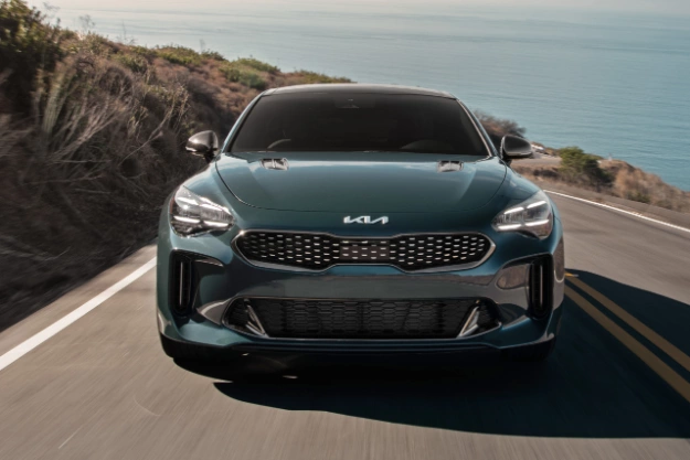2023 Kia Stinger Driving Up A Mountain Road Near The Coast Front View