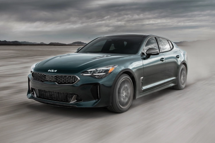 2023 Kia Stinger Utilizing Limited Slip Differential While Driving In A Desert Three-Quarter View