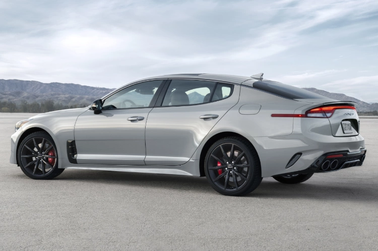 2023 Kia Stinger Parked In Front Of Mountains Rear Three-Quarter View