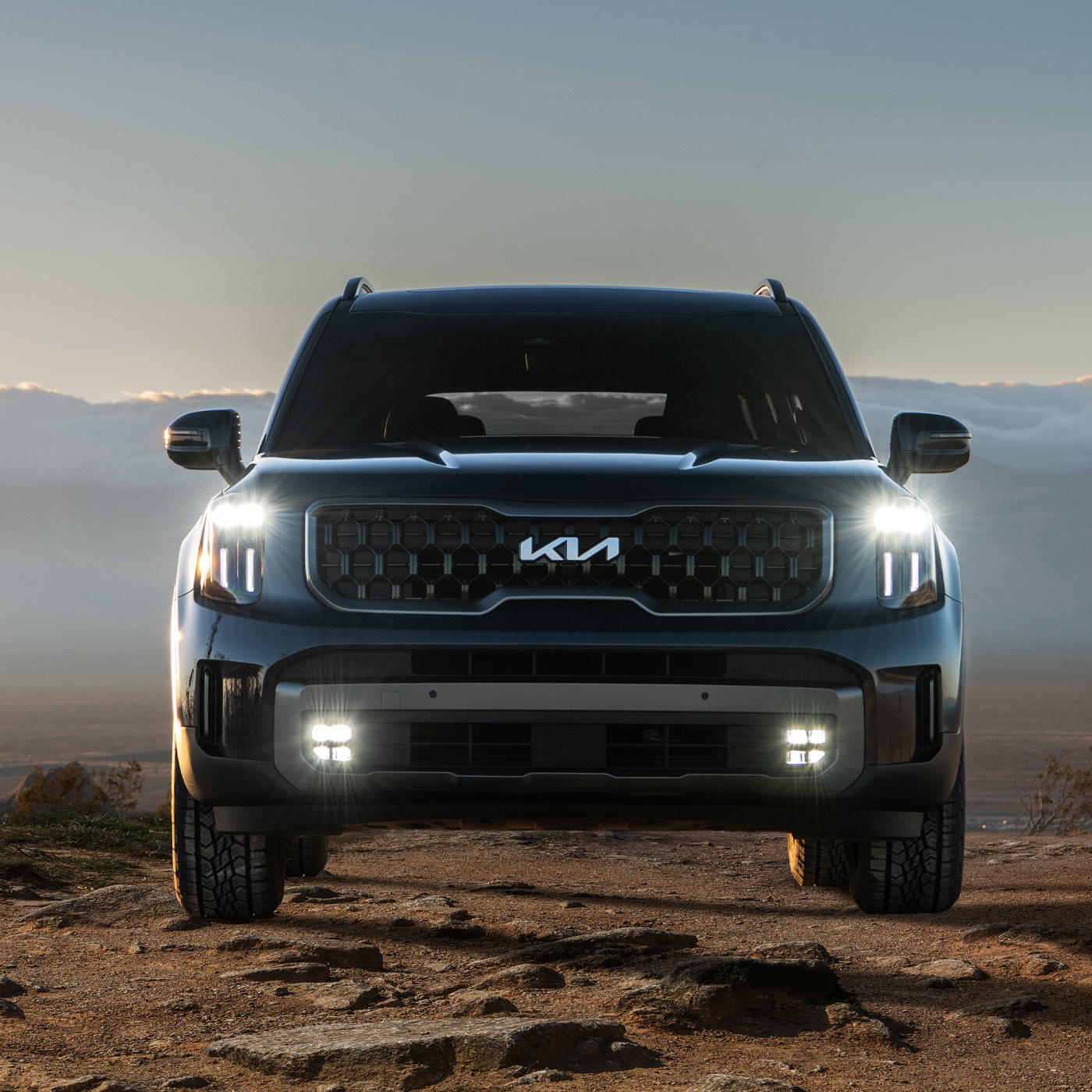 2023 Kia Telluride Driving Off Road Over Rocky Terrain With Increased Ground Clearance Front View
