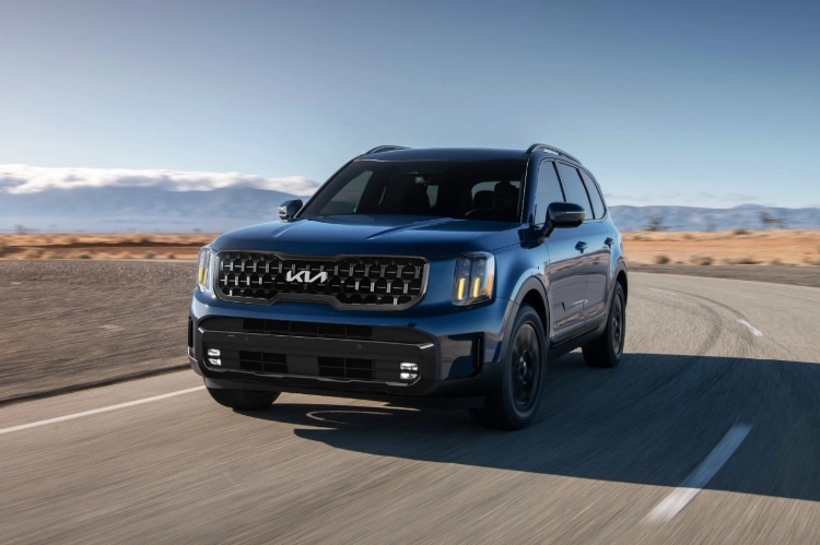 2024 Kia Telluride Driving On An Empty Highway Road In The Desert Three-Quarter View 