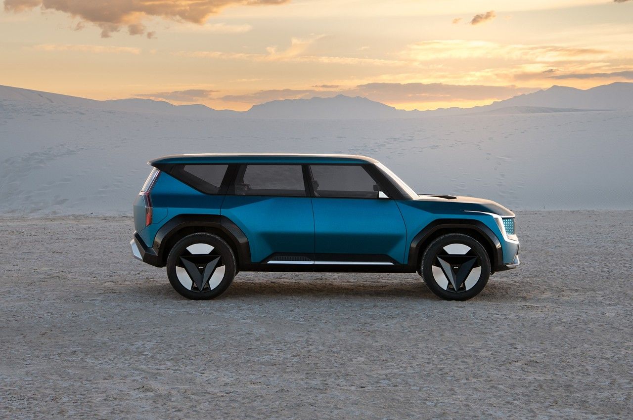 Kia EV9 concept vehicle in blue, side view, featuring wheels with geometric details