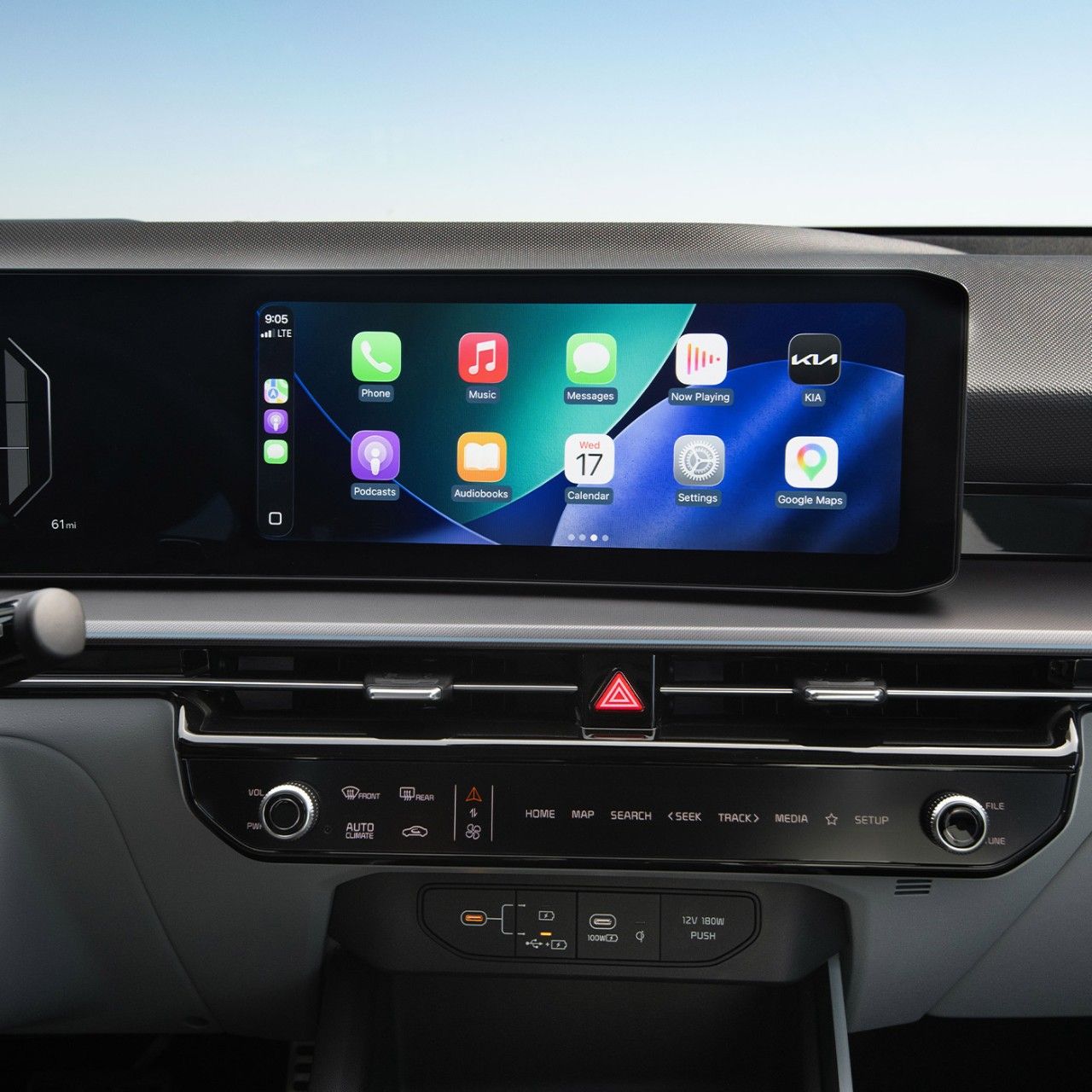 A close-up view of the Kia interior showing the digital display screen, currently featuring popular apps such as Phone, Music, Maps, Messages, Podcasts and more. 