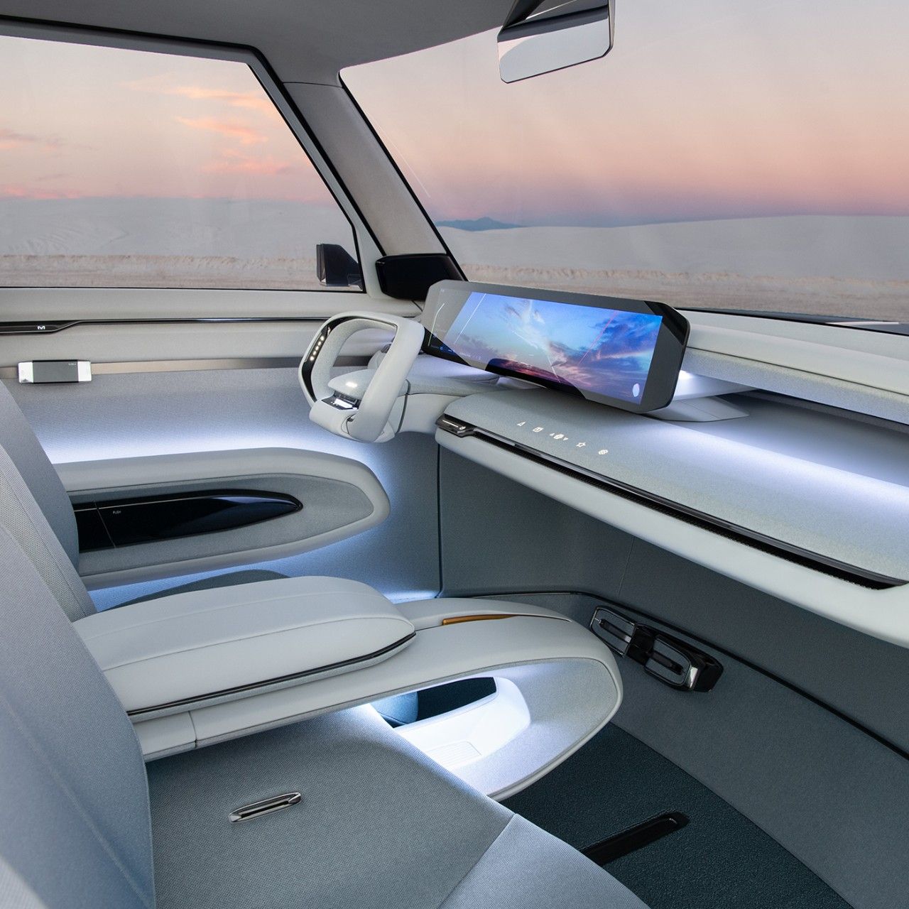 Interior del vehículo conceptual Kia EV9, vista lateral de los asientos de la primera fila, con el volante emergente y el tablero minimalista