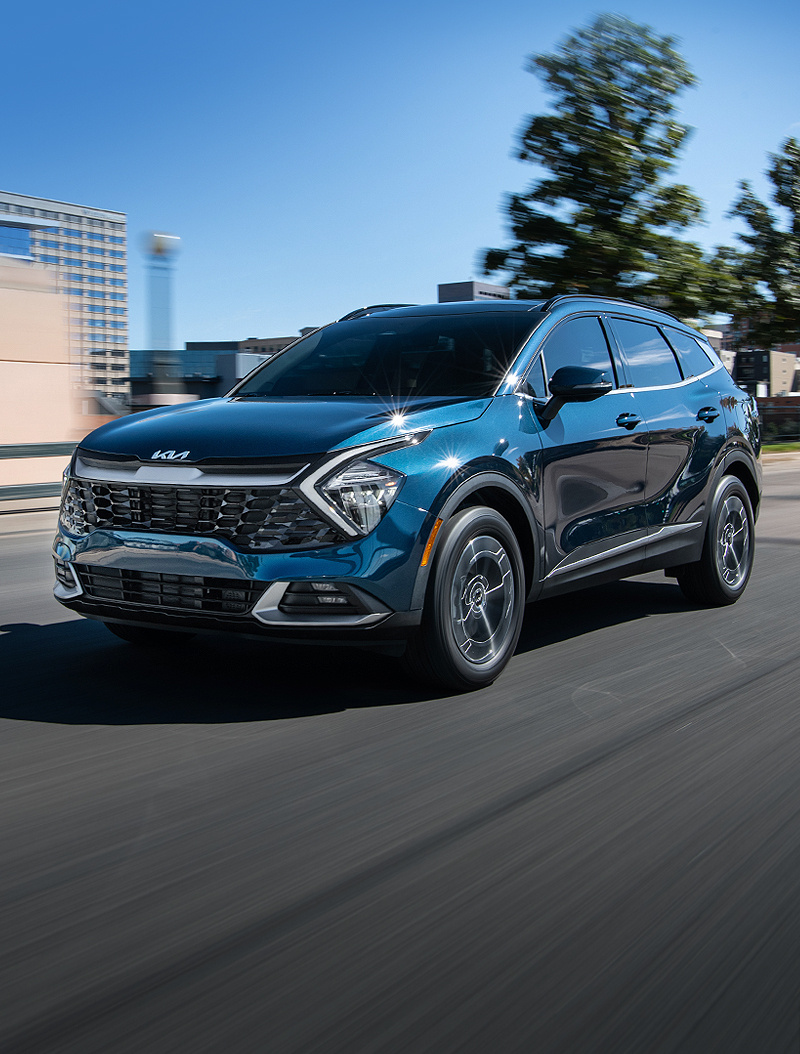 2023 Kia Sportage Hybrid Crossover SUV parked on concrete, three-quarter driver side view