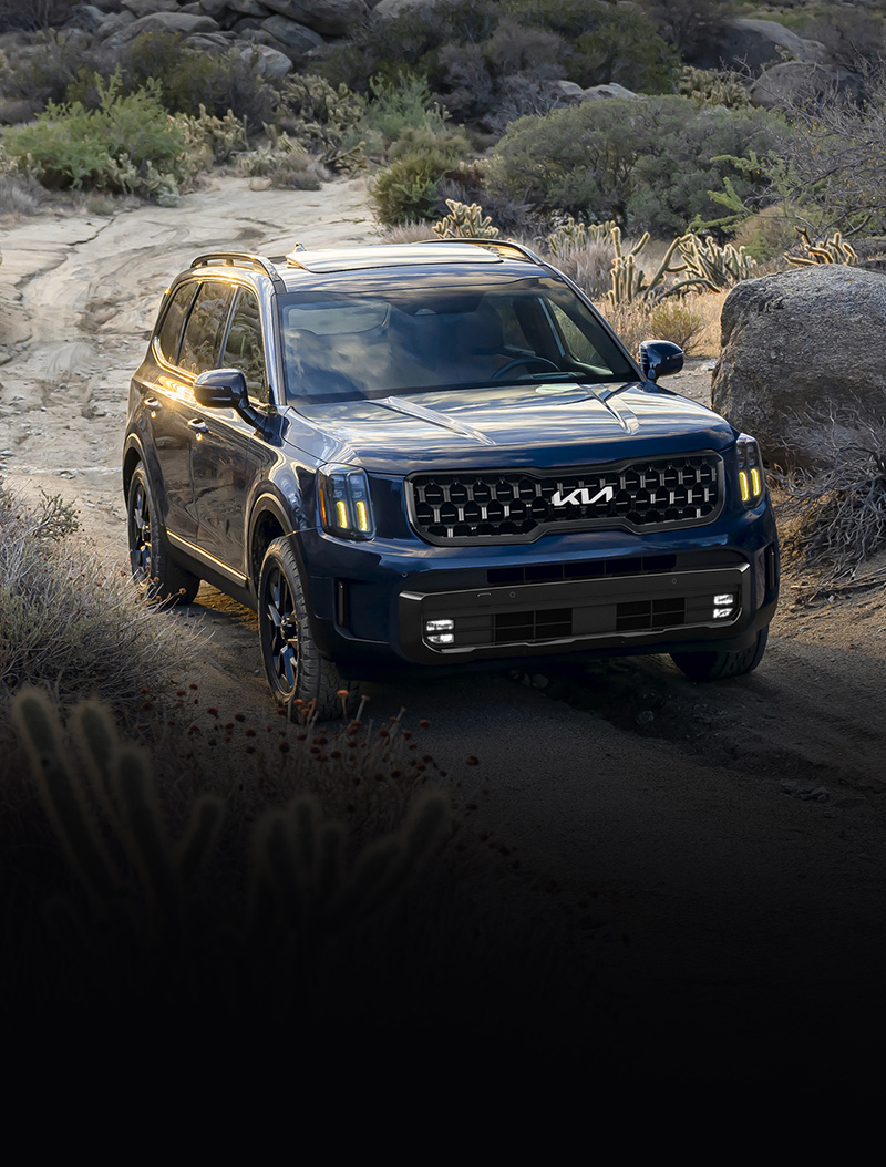 2024 Kia Telluride Driving Through An Off-Road Trail Three-Quarter View